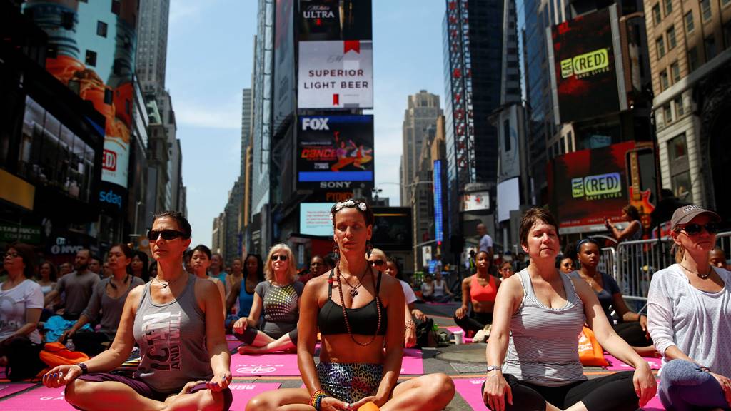 뉴욕 타임 스퀘어 광장에서 요가에 열중하고 있는 뉴요커들 aspirational class